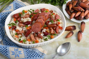 A delicious Brazilian dish of rice with sausage, bacon and pine nuts