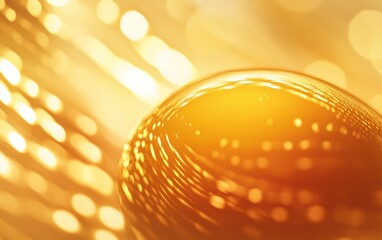 Golden glass sphere reflecting warm bokeh lights. Abstract texture.