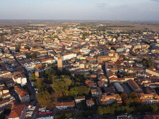 Fototapeta premium Aerial drone view of Rovigo city center, Veneto, showcasing the medieval Donà Tower, ancient castle ruins, and a mix of historic and modern buildings.
