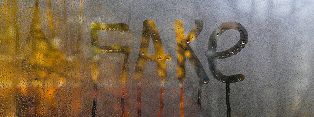 concept fake. inscription on wet glass.