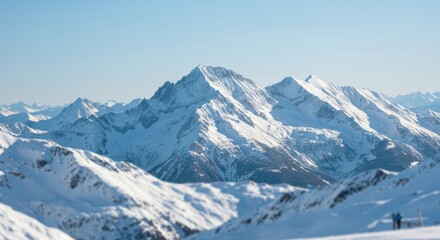Naklejka premium Snowy mountain peaks stretch to the blue sky on a bright, crisp winter day