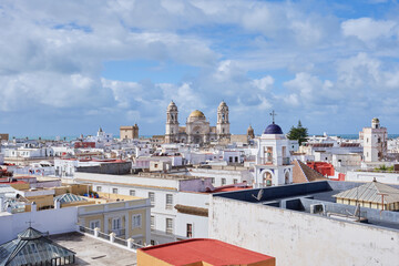 A stunning cityscape of Cádiz, Spain, showcasing the iconic golden dome of the Cádiz Cathedral under a bright sky. A perfect glimpse of this historic coastal city.