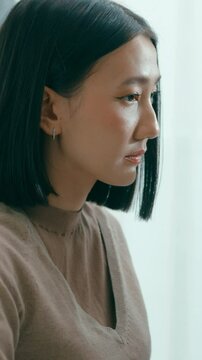 Vertical Screen : Young Asia female freelance typing write prompt AI bot IT app program nomad, video game, terminal with coding language, user interface, designer, big data center on desktop computer.