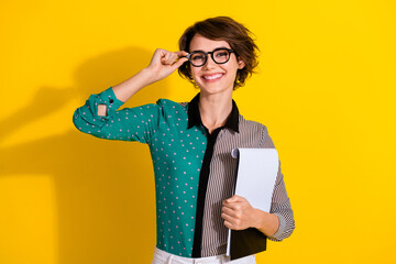Plakat Photo of charming confident woman wear stylish clothes hold paper blank isolated on yellow color background