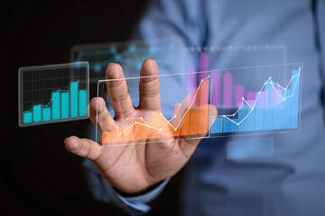 Businessman interacting with holographic financial charts showcasing business growth and market analysis data visualization in a futuristic style