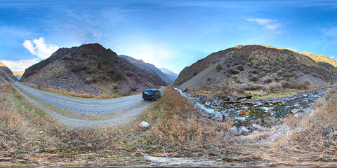 Full Spherical HDRi panorama of gravel road in springtime mountain gorge in Kyrgyzstan in equirectangular projection