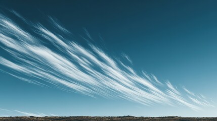 Wispy clouds streak across a vast, clear sky.