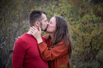 happy young couple posing outdoors in autumn
