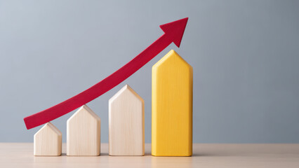 Property loan interest growth concept with wooden house blocks and red arrow showing increase in value and financial success
