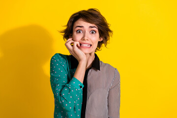 Photo of terrified frightened girl wear stylish striped clothes isolated on yellow color background