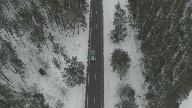 Aerial Drone Shot of Old Soviet Truck Driving Through Snowy Rural Landscape in Harsh Russian Winter