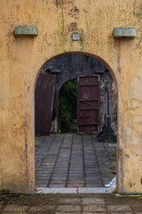 Open stone arch against the background of abandoned ancient buildings and antique ruins. In the...