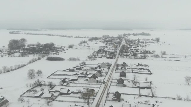 Aerial Drone Shot of Old Soviet Truck Driving Through Snowy Rural Landscape in Harsh Russian Winter
