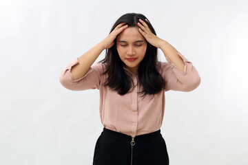 Obraz premium Young Asian woman standing with head down and eyes closed, involved in trouble, work stress, making mistake or having headache, tired from work, isolated on white background.