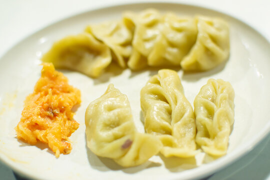 Momo , type of South Asian dumpling; native to Tibet, Nepal, Bhutan and Sikkim. It is similar to Chinese baozi and jiaozi, Mongolian buuz, Japanese gyoza and Korean mandu. Stock photograph.