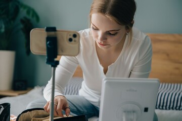 Teenager vlogger preparing makeup for online tutorial video