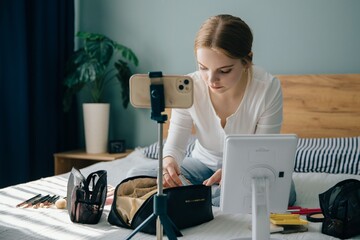 Beauty blogger preparing makeup for recording new video tutorial on smartphone