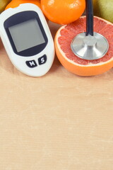 Glucose meter for checking sugar level and fresh ripe fruits. Healthy lifestyle. Source minerals and vitamins. Place for text