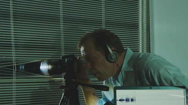 a man in a business suit uses special surveillance