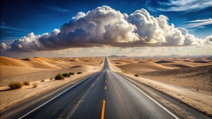 Naklejka premium Endless Asphalt Ribbon Through a Desert Landscape Under a Majestic Cloud Formation