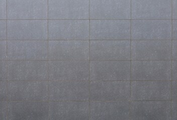 Fototapeta premium Large rectangle gray stone tiles for ventilated facade cladding. Background and texture.