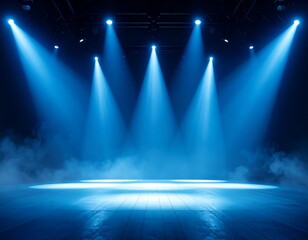Blue stage lights illuminating a smoky empty stage