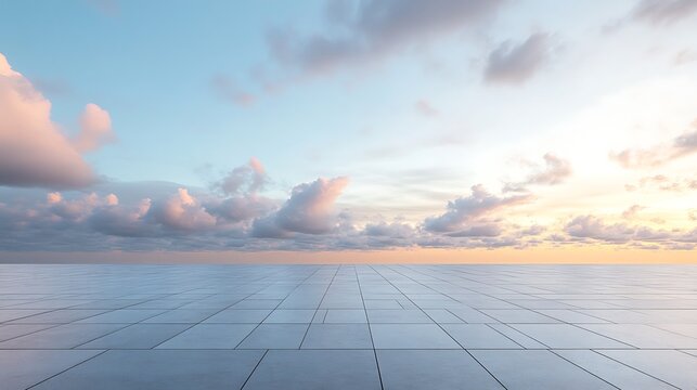 Serene view featuring a symmetrical tile surface extending towards a tranquil sunset under a pastel cloud-filled sky.