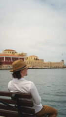 Young man enjoying the view of the venetian fortress in chania, crete