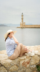 Tourist enjoying view of chania lighthouse in crete, greece