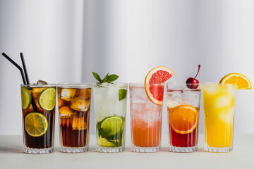 Colorful Assorted Cocktails in Tall Glasses on White Background – Professional Beverage Photography with Ice and Fresh Garnishes (1)