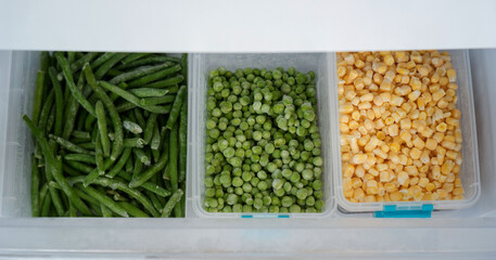 Frozen green beans, peas, and corn preserving freshness in refrigerator