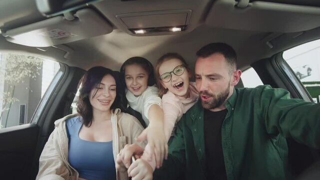 A happy, excited family cuddling up while sitting in a new car and enjoying a purchase at a modern car dealership. Concept of renting, test driving or buying a new car.