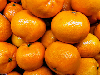 oranges in a market. Close-up of fresh oranges stacked together. Perfect for health, nutrition, fruit market, vitamin C, organic produce, and tropical agriculture visual content.. 