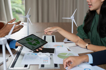 ESG Discussion with Digital Tools. Team analyzing sustainability data.