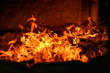 Close-up view of blazing fire inside a temple furnace burning joss paper during a traditional Taiwanese worship ritual