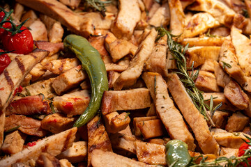 Close-up of sliced and grilled meat served with fresh pepper and tomato. The juicy, flavorful dish showcases vibrant colors and appetizing textures, perfect for culinary and food-related content.