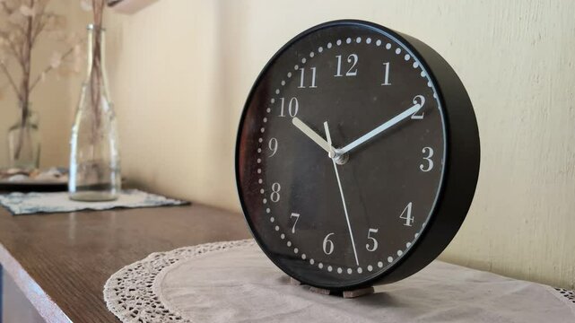 A clock on a desk in a home - closeup