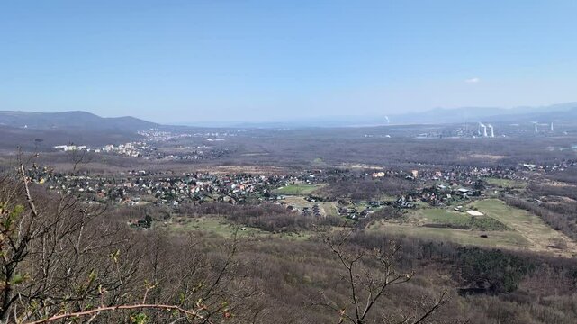 A vast, forested landscape with villages during fall - top view