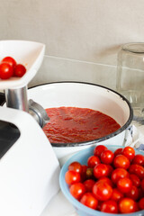 Homemade tomato preserves and tomato juice, canned and sealed for winter storage, maintaining flavor and freshness