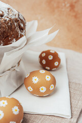 Traditional Easter cake with hand-painted daisy eggs on fabric. Homemade festive baked goods and decor...