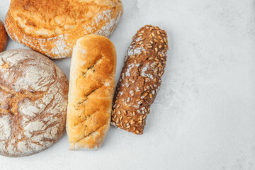 Freshly baked artisan bread assortment on a light surface in natural setting