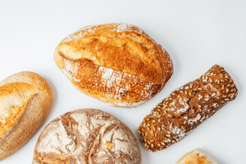 Baked bread varieties displayed on a clean surface with natural lighting