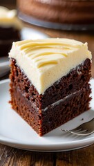 Delicious slice of rich chocolate cake with creamy frosting on white plate - National German Chocolate Cake Day
