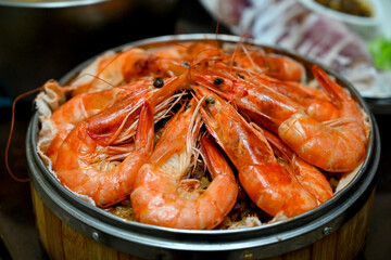 Close-up of steamed shrimp in a bamboo basket, part of a traditional Taiwanese meal