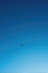 solitary airplane tail against vast blue sky conveys serenity and modern travel essence