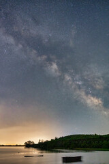 The Milky Way glows brilliantly over the still waters of Lake Kerkini, Greece