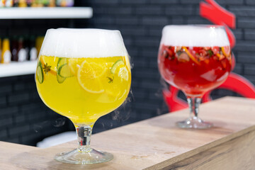 Colorful cocktails served in large glasses at a vibrant bar setting