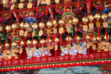 Taiwan June 2, 2025: Golden prayer plaques with red tassels hanging in a Taiwanese temple,...