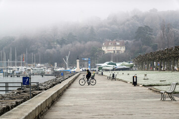 Cycliste sur les quais du lac de Genève en hiver