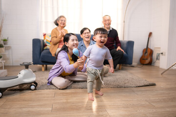 Happy multi-generational Asian family enjoying quality time together at home